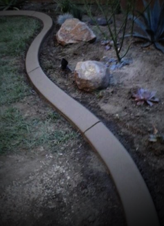 Colored concrete curb bordering a planter